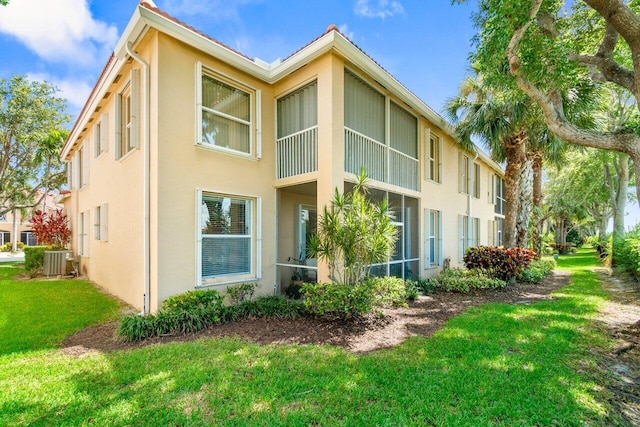 12480 Crystal Pointe Dr Unit 102, Boynton Beach, FL 33437 - rear view of property featuring stucco siding and a lawn