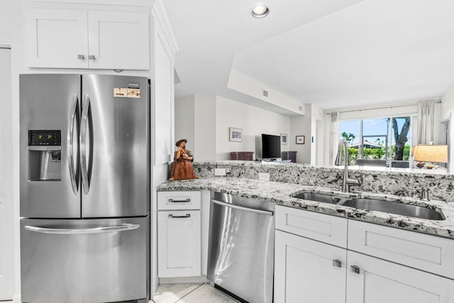 12480 Crystal Pointe Dr Unit 102, Boynton Beach, FL 33437 - kitchen with stainless steel appliances, light stone countertops, white cabinets, light marble finish floors, and recessed lighting