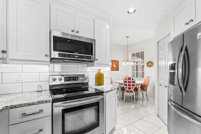 12480 Crystal Pointe Dr Unit 102, Boynton Beach, FL 33437 - kitchen featuring stainless steel appliances, a chandelier, decorative backsplash, white cabinets, and light stone counters