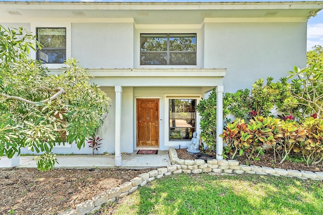 2438 Inland Cove Rd, Palm Beach Gardens, FL 33410 - entrance to property with stucco siding and covered porch