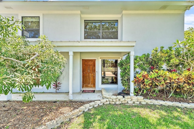 2438 Inland Cove Rd, Palm Beach Gardens, FL 33410 - property entrance featuring stucco siding and a porch