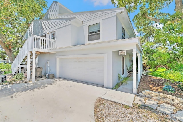 2438 Inland Cove Rd, Palm Beach Gardens, FL 33410 - view of front facade with stucco siding, an attached garage, concrete driveway, and stairs