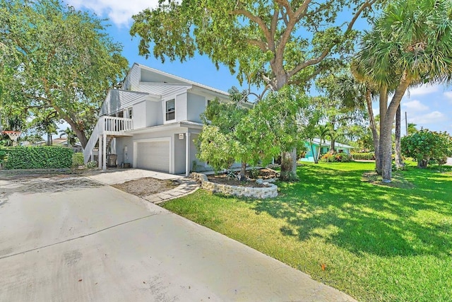 2438 Inland Cove Rd, Palm Beach Gardens, FL 33410 - view of side of property featuring stucco siding, a garage, a yard, concrete driveway, and stairs