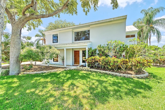 2438 Inland Cove Rd, Palm Beach Gardens, FL 33410 - view of front facade with stucco siding and a front yard