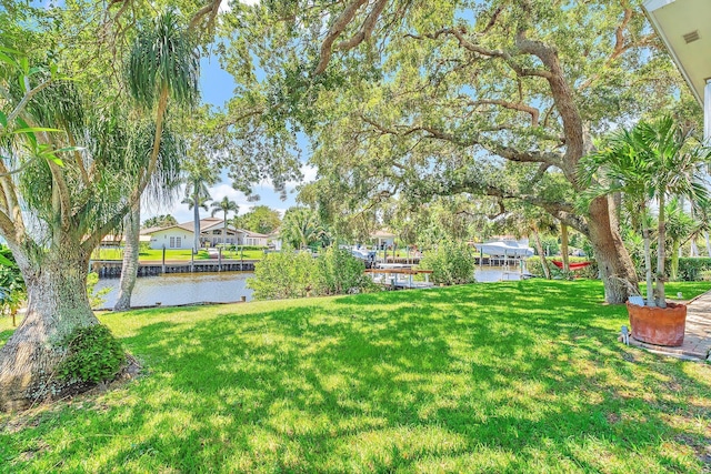 2438 Inland Cove Rd, Palm Beach Gardens, FL 33410 - view of grassy yard featuring a water view, a residential view, and a boat dock