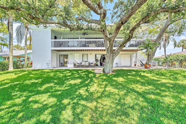 2438 Inland Cove Rd, Palm Beach Gardens, FL 33410 - back of house with stucco siding, a lawn, a ceiling fan, stairs, and a wooden deck
