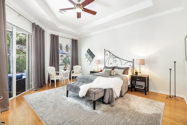 63 Lake Eden Dr, Boynton Beach, FL 33435 - bedroom with a tray ceiling, light wood-type flooring, crown molding, access to outside, and ceiling fan