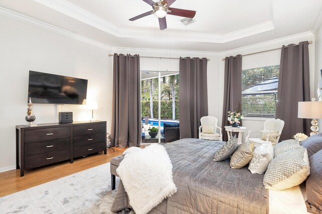 63 Lake Eden Dr, Boynton Beach, FL 33435 - bedroom featuring wood finished floors, access to exterior, crown molding, a raised ceiling, and a ceiling fan