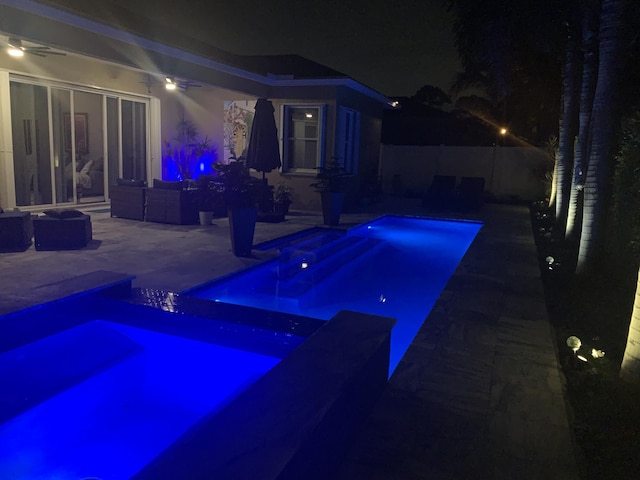 63 Lake Eden Dr, Boynton Beach, FL 33435 - pool at twilight with a patio, a pool with connected hot tub, and an outdoor hangout area