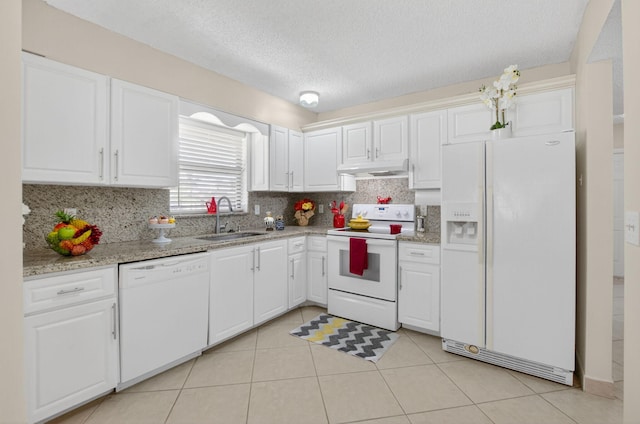 9521 Boca Cove Cir Unit 508, Boca Raton, FL 33428 - kitchen featuring white appliances, under cabinet range hood, decorative backsplash, white cabinetry, and a textured ceiling