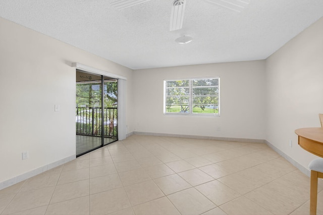 9521 Boca Cove Cir Unit 508, Boca Raton, FL 33428 - spare room featuring a textured ceiling, light tile patterned floors, and ceiling fan