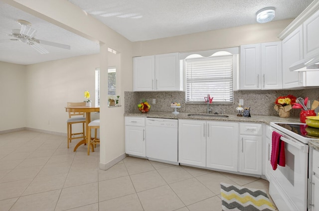 9521 Boca Cove Cir Unit 508, Boca Raton, FL 33428 - kitchen with white appliances, decorative backsplash, light tile patterned floors, white cabinetry, and light stone counters