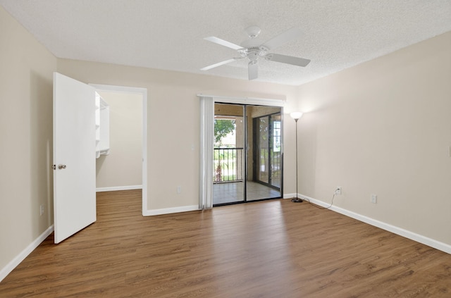 9521 Boca Cove Cir Unit 508, Boca Raton, FL 33428 - spare room with wood finished floors, ceiling fan, and a textured ceiling