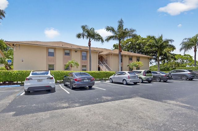 9521 Boca Cove Cir Unit 508, Boca Raton, FL 33428 - view of building exterior with uncovered parking and stairway