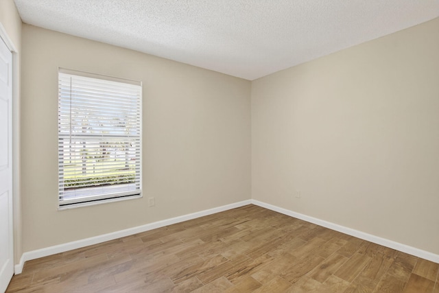 9521 Boca Cove Cir Unit 508, Boca Raton, FL 33428 - empty room featuring light wood-style floors and a textured ceiling