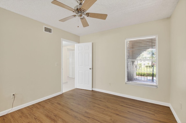 9521 Boca Cove Cir Unit 508, Boca Raton, FL 33428 - spare room featuring wood finished floors, ceiling fan, and a textured ceiling