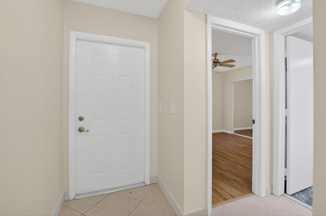 9521 Boca Cove Cir Unit 508, Boca Raton, FL 33428 - hall with light tile patterned flooring and a textured ceiling