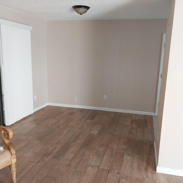 2482 SE Floresta Dr, Port Saint Lucie, FL 34984 - unfurnished room featuring wood finished floors and a textured ceiling