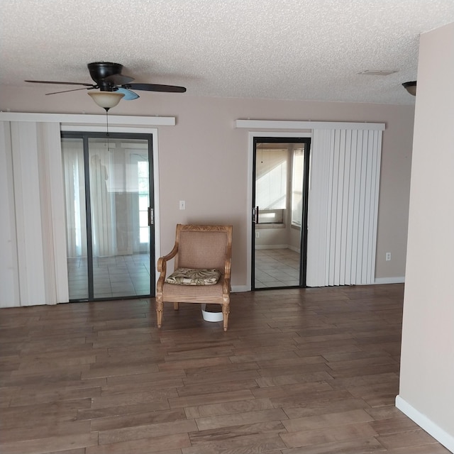 2482 SE Floresta Dr, Port Saint Lucie, FL 34984 - sitting room featuring a textured ceiling, ceiling fan, and wood finished floors