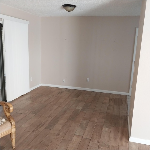 2482 SE Floresta Dr, Port Saint Lucie, FL 34984 - spare room with a textured ceiling and wood finished floors