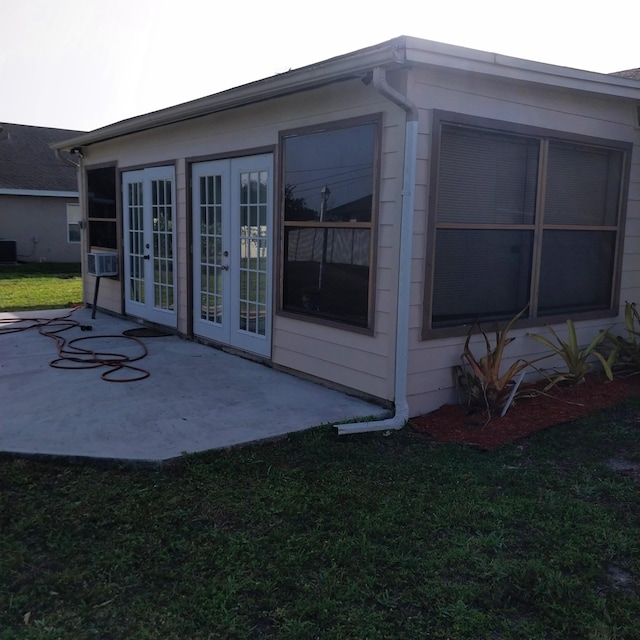 2482 SE Floresta Dr, Port Saint Lucie, FL 34984 - view of property exterior with french doors, a patio, and a lawn