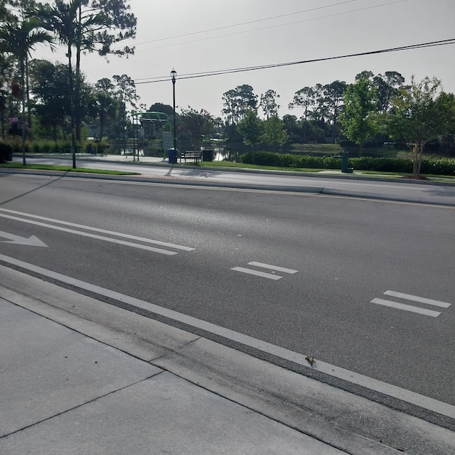 2482 SE Floresta Dr, Port Saint Lucie, FL 34984 - view of asphalt street featuring sidewalks, curbs, and street lighting