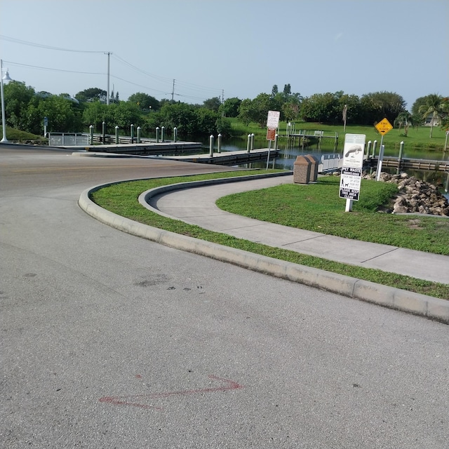2482 SE Floresta Dr, Port Saint Lucie, FL 34984 - view of asphalt street with curbs and traffic signs
