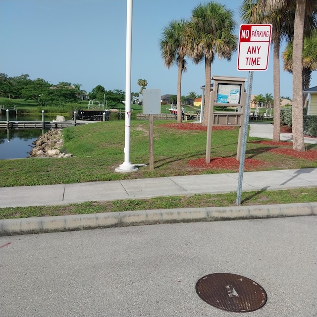 2482 SE Floresta Dr, Port Saint Lucie, FL 34984 - view of community with a yard and a water view