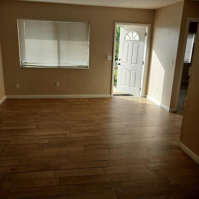 2482 SE Floresta Dr, Port Saint Lucie, FL 34984 - entrance foyer with wood finished floors and a textured ceiling