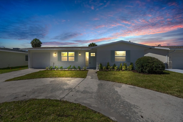400 Riverside Dr, Palm Beach Gardens, FL 33410 - single story home featuring an attached garage, driveway, stucco siding, and a front lawn