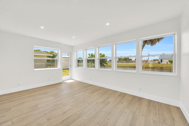 400 Riverside Dr, Palm Beach Gardens, FL 33410 - empty room with light wood-type flooring, recessed lighting, and a water view
