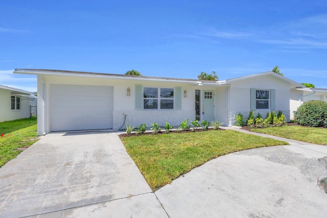 400 Riverside Dr, Palm Beach Gardens, FL 33410 - ranch-style home with a garage, a front yard, concrete driveway, and stucco siding