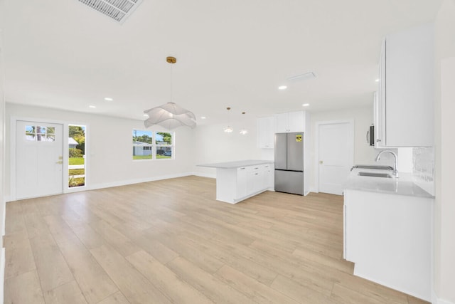 400 Riverside Dr, Palm Beach Gardens, FL 33410 - unfurnished living room featuring light wood-style flooring and recessed lighting