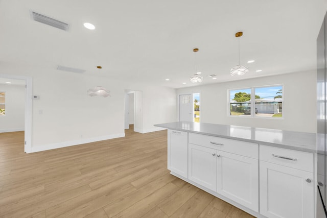 400 Riverside Dr, Palm Beach Gardens, FL 33410 - kitchen with open floor plan, white cabinets, light countertops, recessed lighting, and light wood finished floors