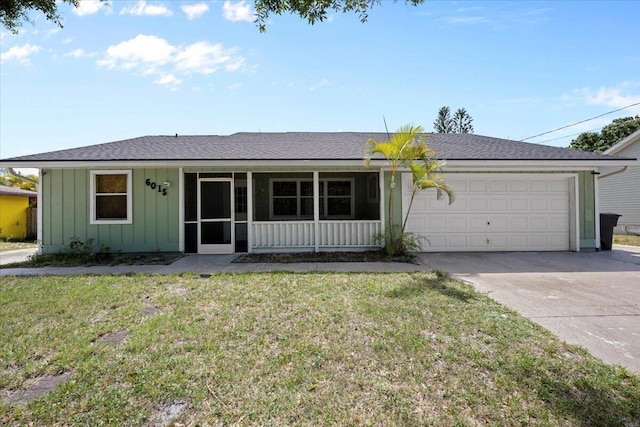 6015 Raintree Trl, Fort Pierce, FL 34982 - ranch-style house with board and batten siding, driveway, a garage, a front lawn, and roof with shingles