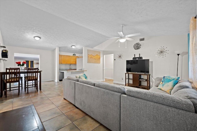 6015 Raintree Trl, Fort Pierce, FL 34982 - living room with a textured ceiling, ceiling fan, light tile patterned flooring, and lofted ceiling