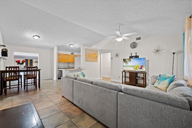 6015 Raintree Trl, Fort Pierce, FL 34982 - living room featuring a textured ceiling, a ceiling fan, light tile patterned floors, and lofted ceiling