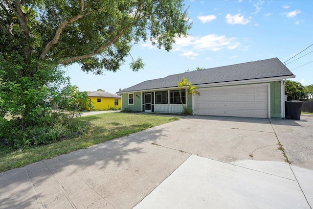 6015 Raintree Trl, Fort Pierce, FL 34982 - ranch-style house with concrete driveway, a garage, and a front yard