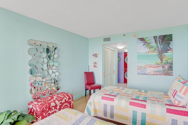 4101 N Ocean Blvd Unit 908, Boca Raton, FL 33431 - bedroom featuring wood finished floors and a textured ceiling