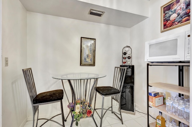1102 Green Pine Blvd Unit A1, West Palm Beach, FL 33409 - tiled dining room with baseboards