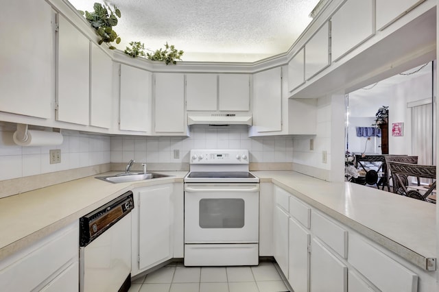 1102 Green Pine Blvd Unit A1, West Palm Beach, FL 33409 - kitchen featuring white appliances, under cabinet range hood, tasteful backsplash, light countertops, and a textured ceiling