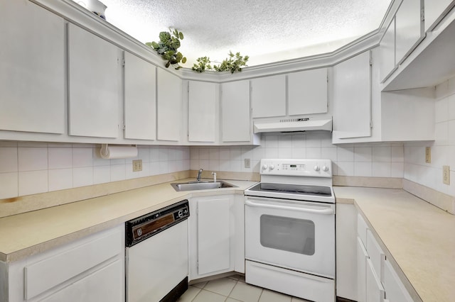 1102 Green Pine Blvd Unit A1, West Palm Beach, FL 33409 - kitchen featuring white appliances, under cabinet range hood, light countertops, decorative backsplash, and a textured ceiling