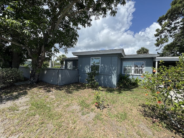 1801 N 25th St, Fort Pierce, FL 34947 - back of property featuring concrete block siding and a yard