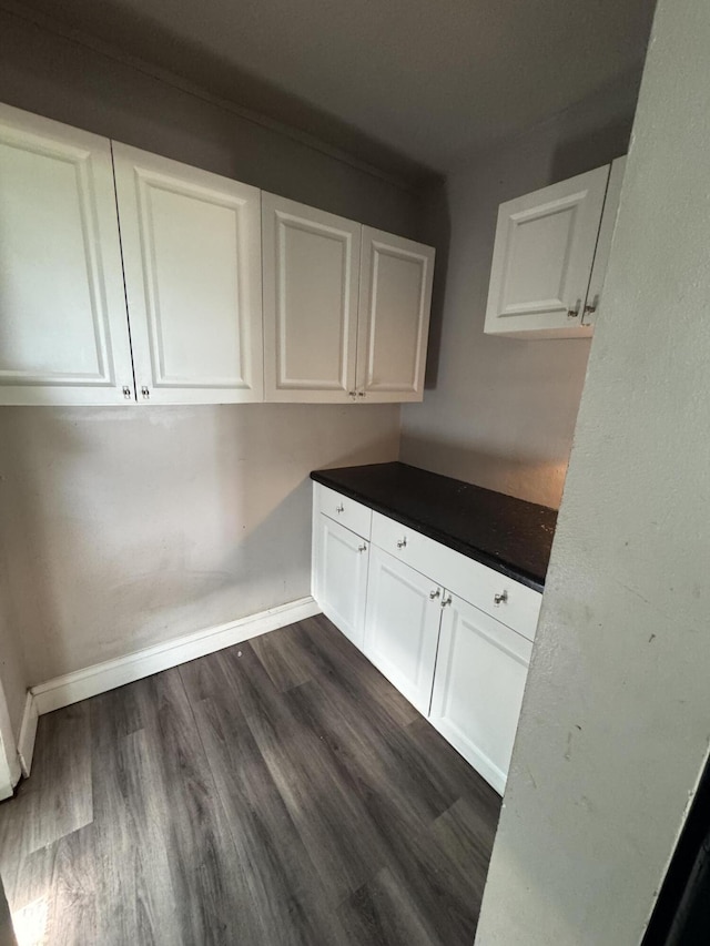 1801 N 25th St, Fort Pierce, FL 34947 - kitchen featuring white cabinetry, dark wood finished floors, and dark countertops