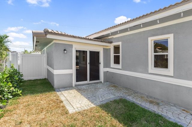 1555 SE 7th St, Deerfield Beach, FL 33441 - back of property with stucco siding, a tile roof, and a patio area