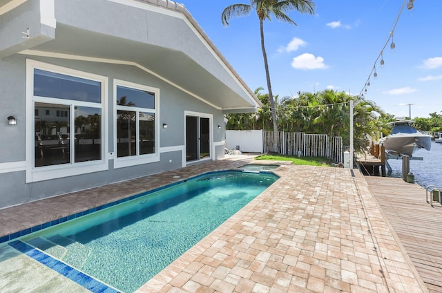 1555 SE 7th St, Deerfield Beach, FL 33441 - view of swimming pool with a patio, a pool with connected hot tub, boat lift, and a boat dock