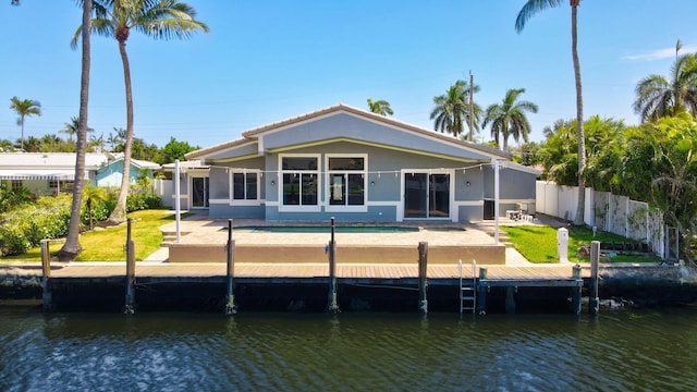1555 SE 7th St, Deerfield Beach, FL 33441 - back of property with a water view, stucco siding, and a patio
