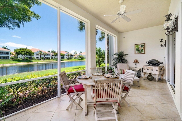 112 Palm Bay Dr Unit A, Palm Beach Gardens, FL 33418 - sunroom / solarium with a water view, tile patterned flooring, lofted ceiling, a residential view, and a textured ceiling