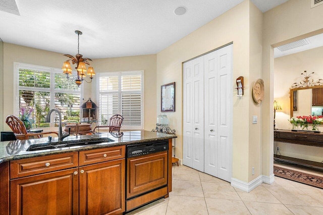112 Palm Bay Dr Unit A, Palm Beach Gardens, FL 33418 - kitchen with paneled dishwasher, dark stone counters, brown cabinetry, a chandelier, and light tile patterned floors