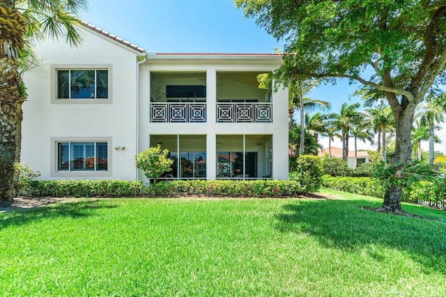 112 Palm Bay Dr Unit A, Palm Beach Gardens, FL 33418 - rear view of house featuring stucco siding, a lawn, and a tile roof